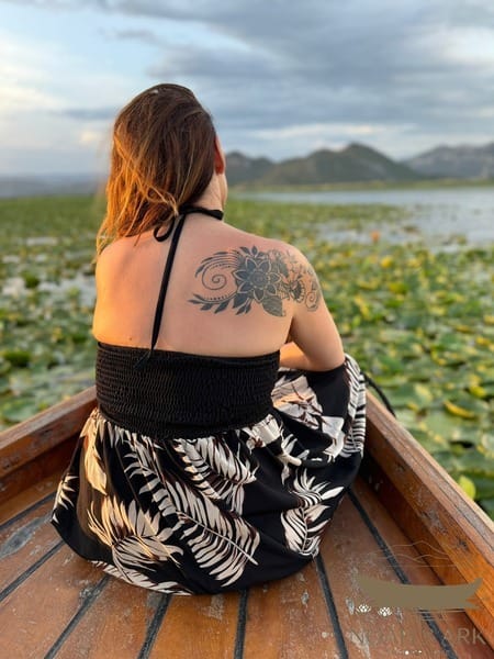 Traditional wooden tour boat on Skadar Lake among water lilies near Virpazar, Montenegro