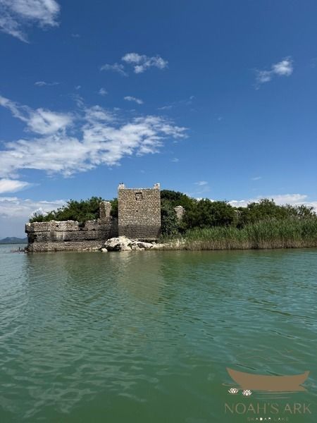 Traditional wooden boat and fast sport boat on Skadar Lake near Virpazar, Montenegro